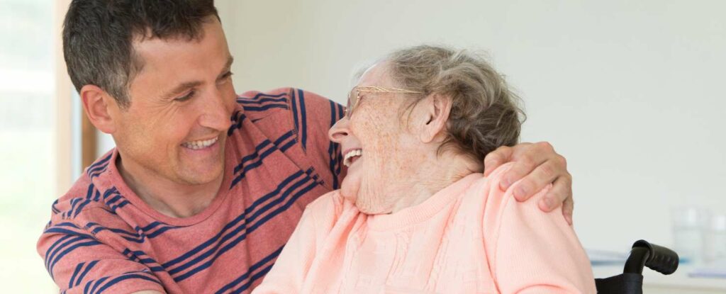 image of a male caregiver helping out an older woman. do you need to pay taxes for the caregiver?