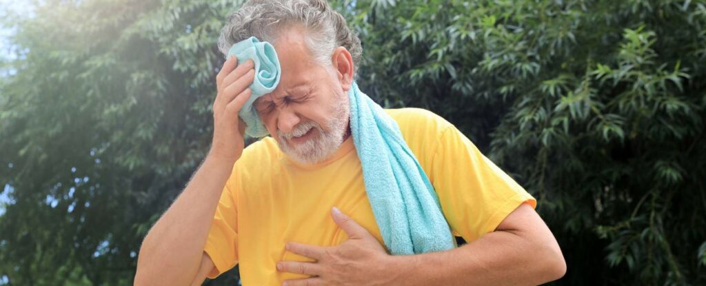 man is dehydrated and holding his head