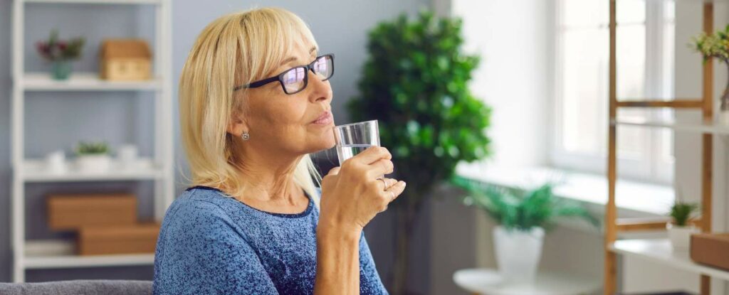 a woman sipping on water