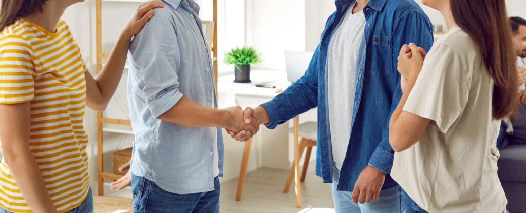 family members shaking hand for a financial agreement on caregiving costs