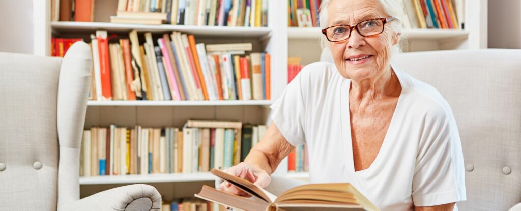 woman at the library reading books on potential credit card fraud