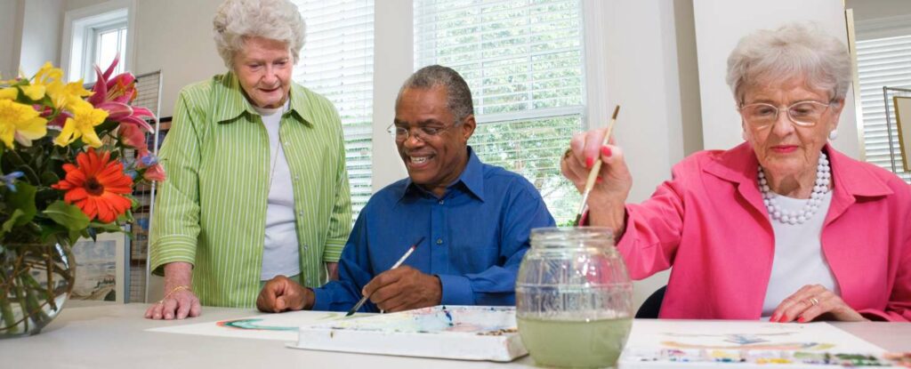 seniors painting at an adult day care center