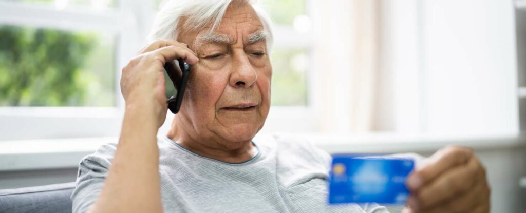 man on the phone with a medicare card scammer